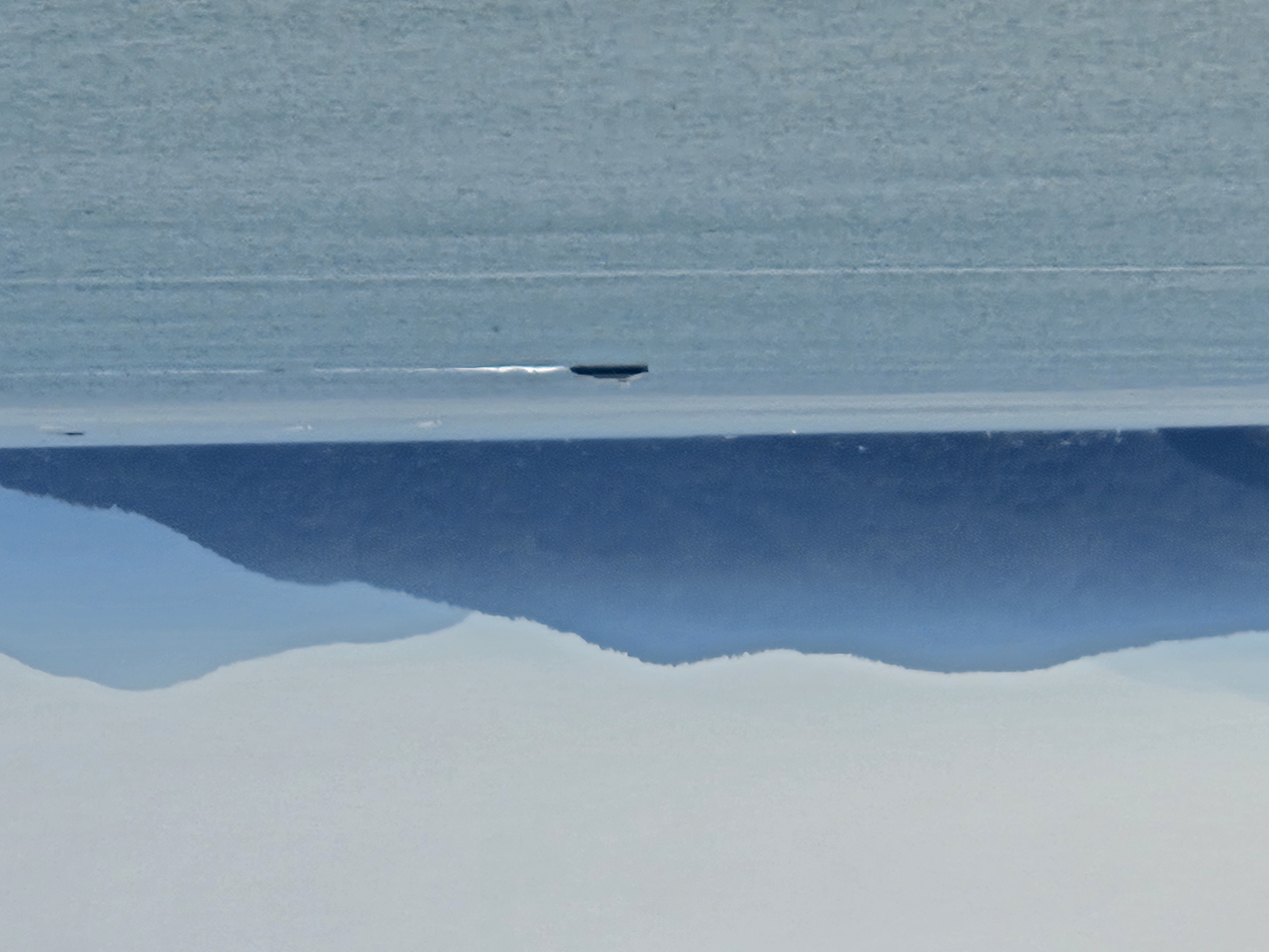 Blue coastal water and layered mountains across the Pacific coastline